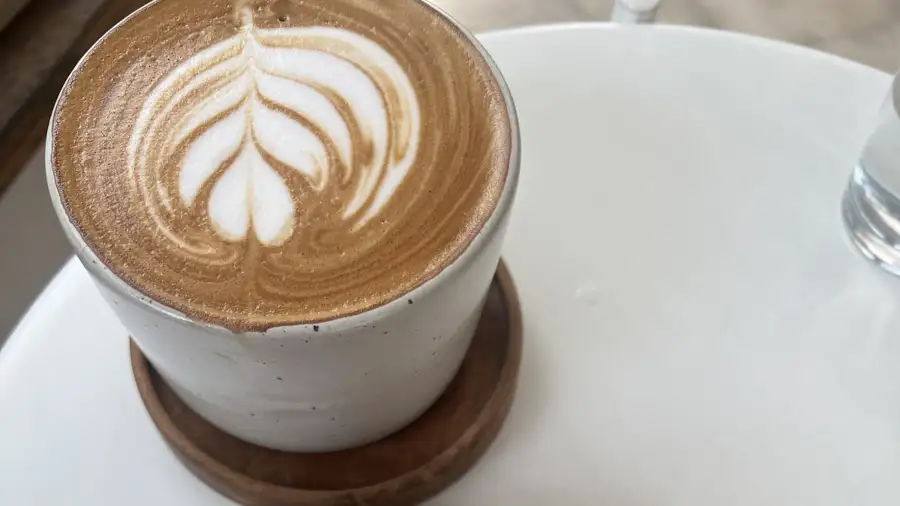 A coffee with latte art at BGS Uluwatu, a surf shop and coffee bar